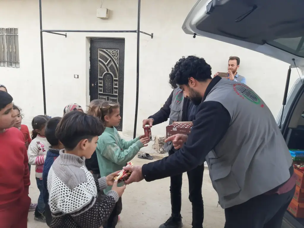 Dağıtım için sıraya giren çocuklar ve gönüllüler